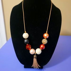 Large beaded necklace with tassel embellishment